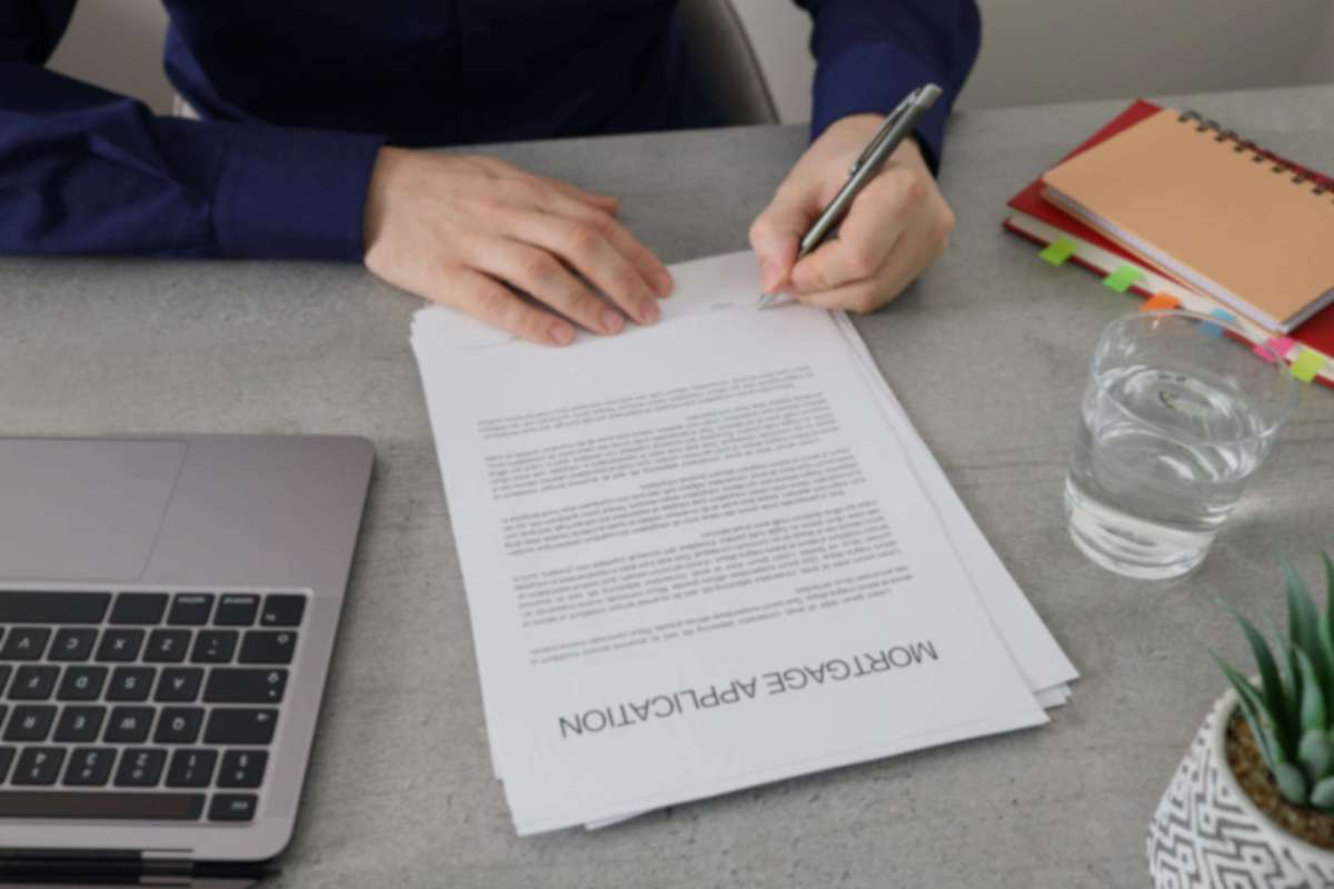 A person signing a mortgage application.