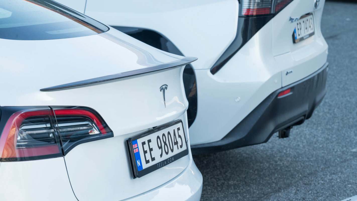 Two Teslas in a parking lot.