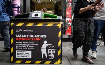 An anti-Smart Glasses sign on a trash bin.