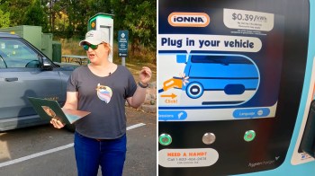 A woman stands with a laptop near an electric vehicle charging station displaying instructions to plug in a vehicle.