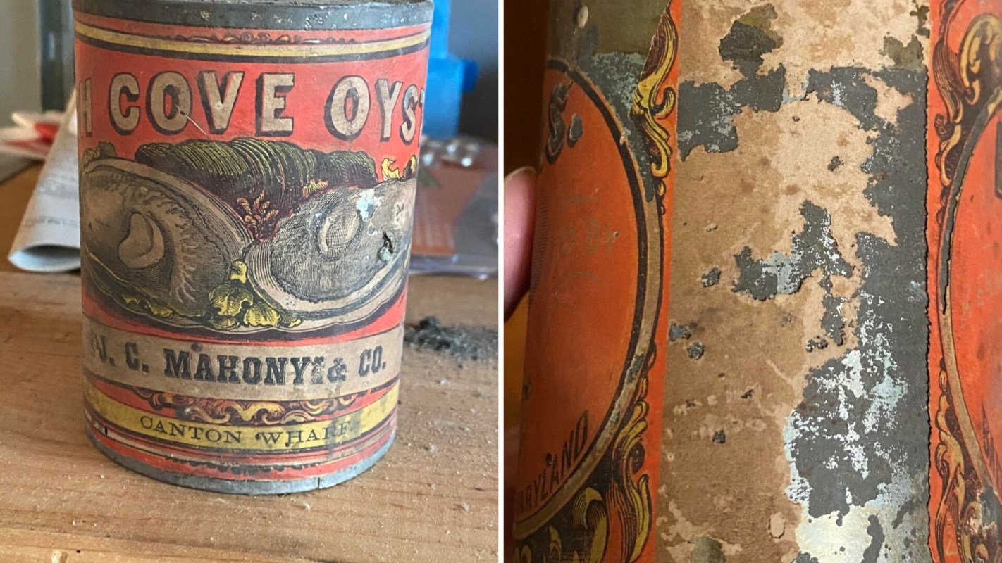 An antique metal oyster can with faded graphic design and text.