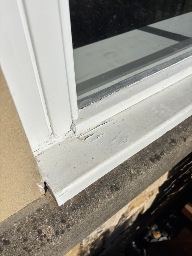 Cracked paint on a window frame.