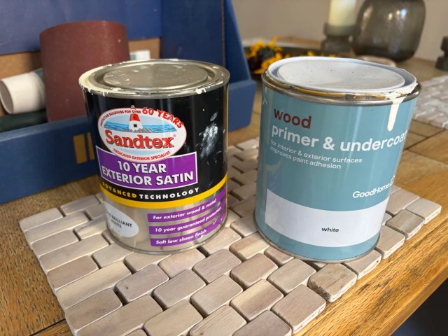 Two cans of wood primer and exterior satin.