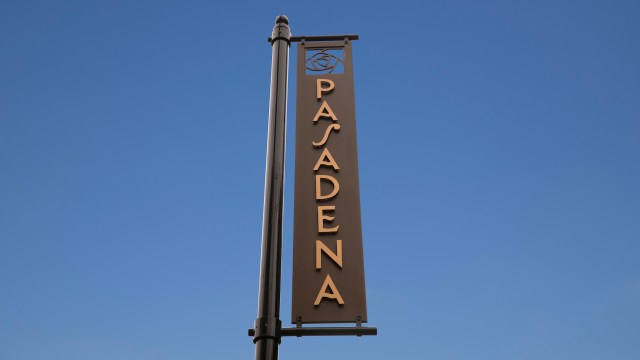 A sign displaying the word "Pasadena" against a clear blue sky.