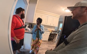 People talking in a kitchen.