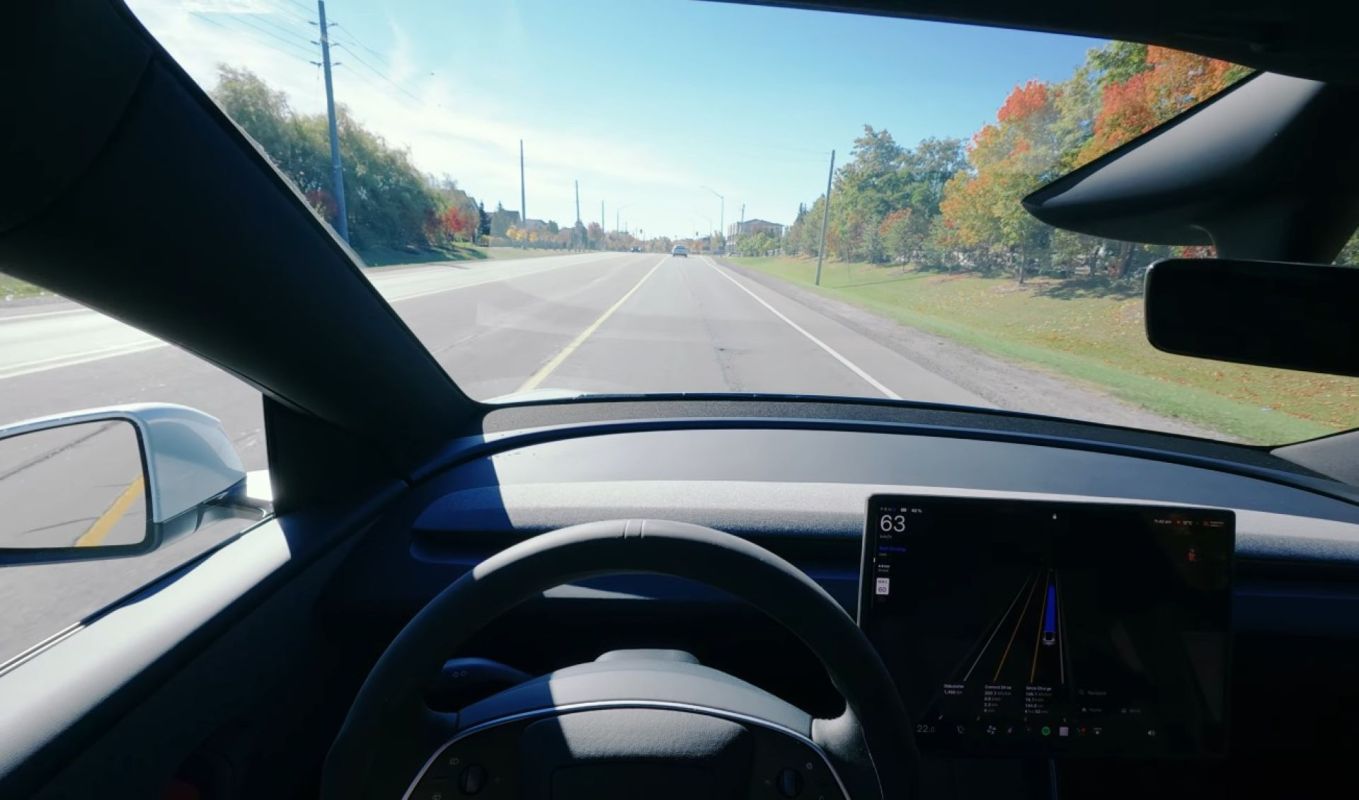 A person driving a Tesla.