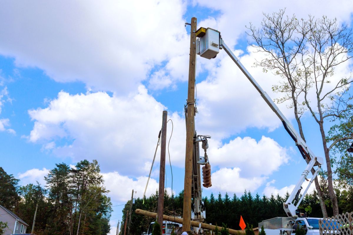 Workers working on a power pole.