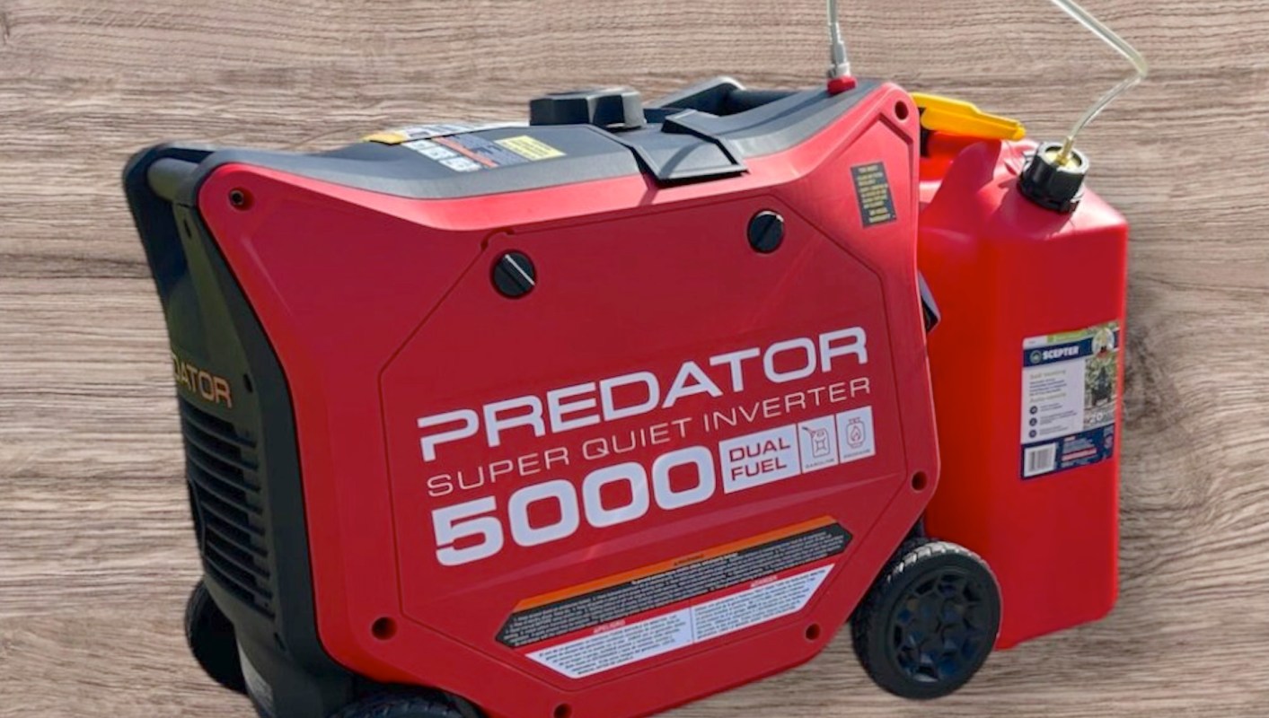 A red Predator 5000 dual fuel inverter generator with a fuel canister beside it.