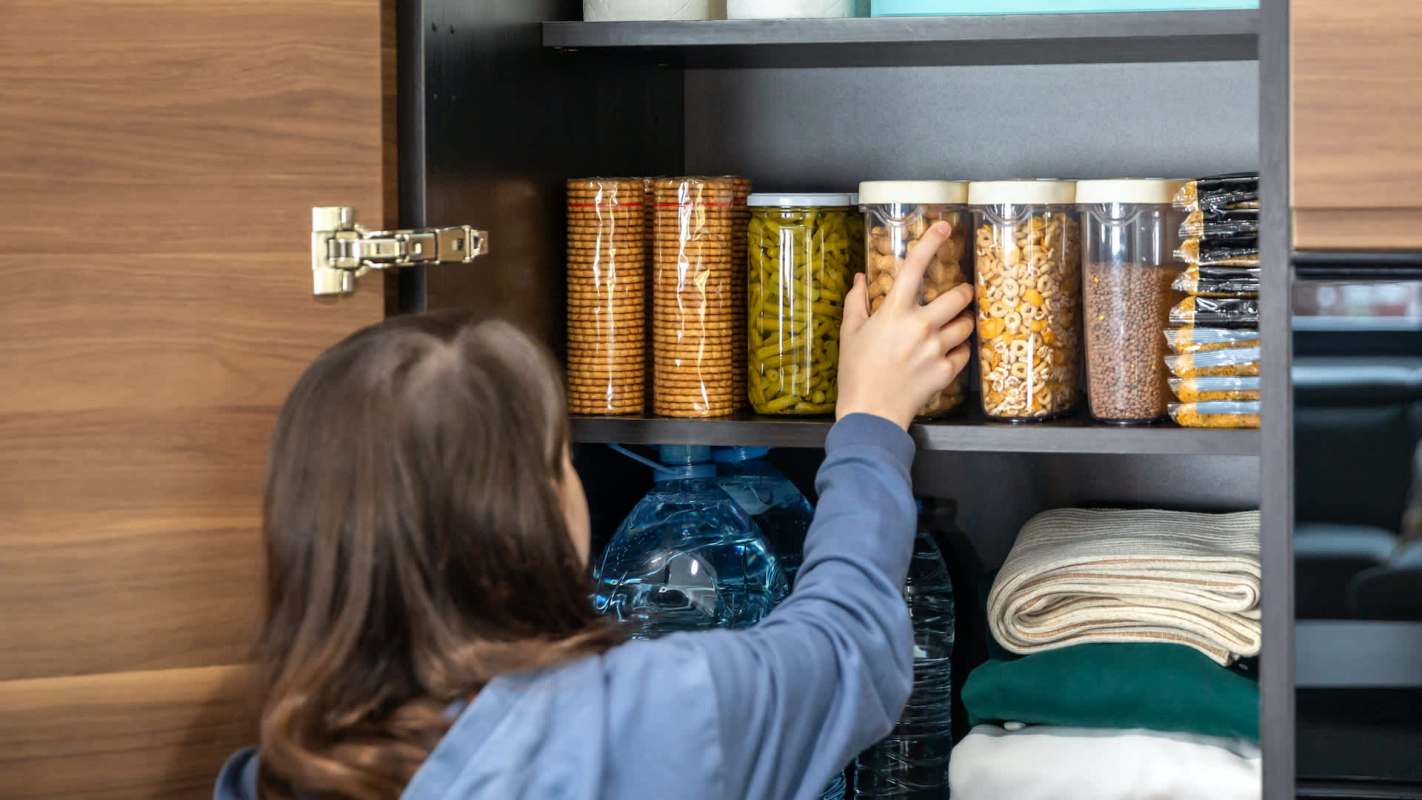 A person organizing a pantry.