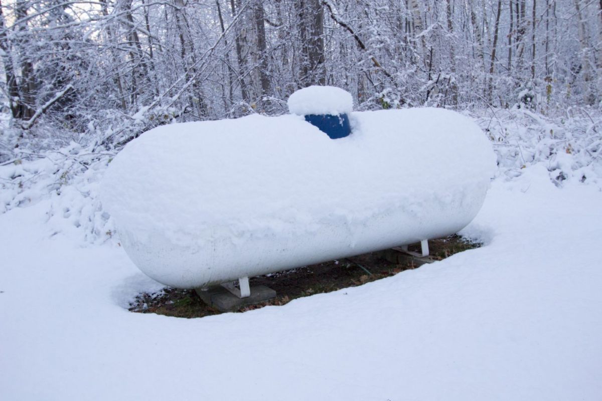 A propane tank covered in snow.