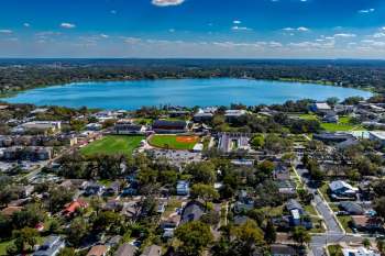 An aerial view of Lakeland Florida with a lake surrounded by residential areas and a baseball field.