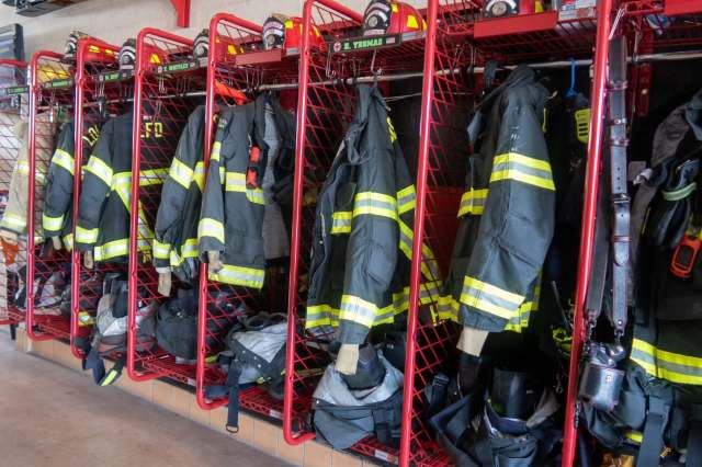 Firefighter gear in storage racks.