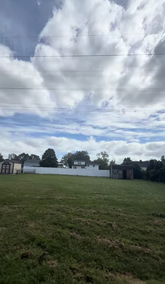 Power lines over a patch of grass.