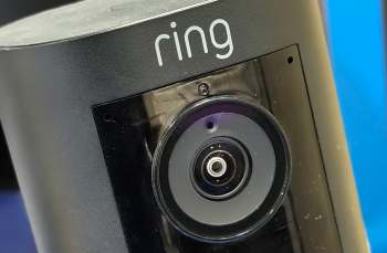 A black security camera with the brand name "ring" visible.