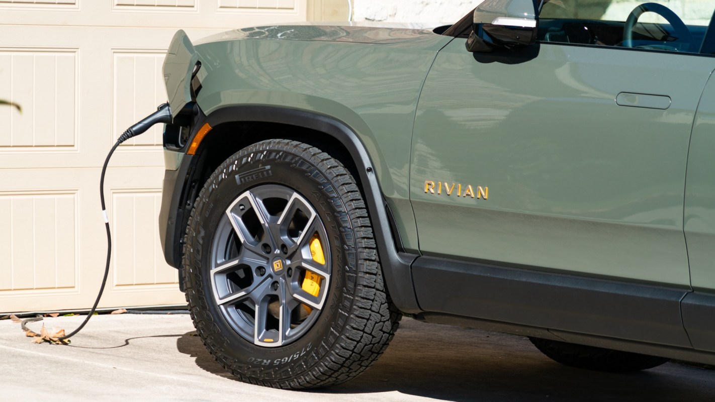 A Rivian plugged into a home charging station.