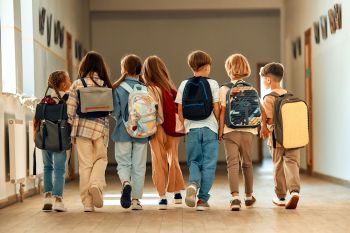School kids walking down a hallway.