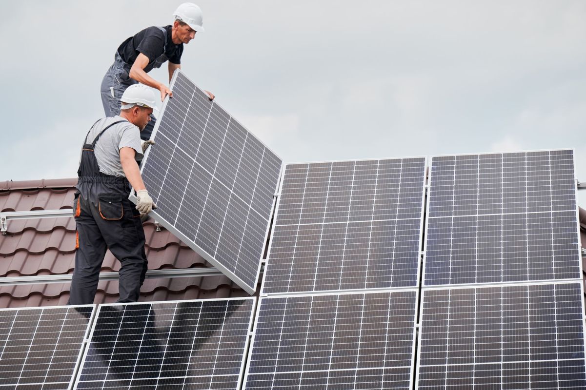 People installing solar panels.