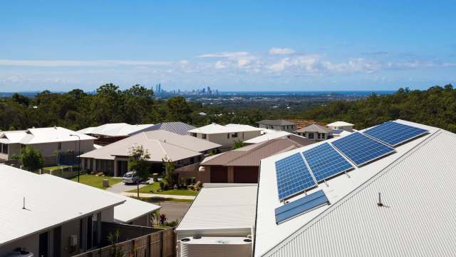 A house with rooftop solar panels.