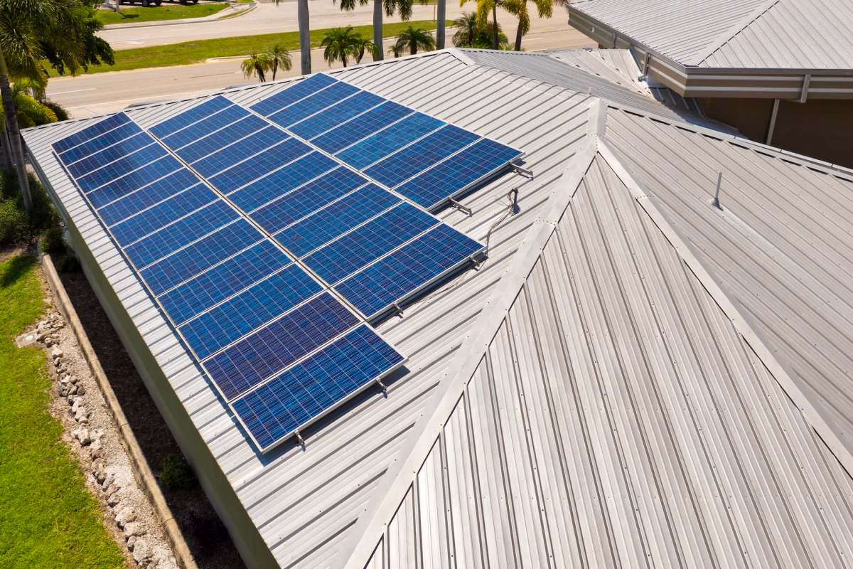 Solar panels installed on a metal roof of a building.