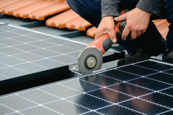 A person installing solar panels.