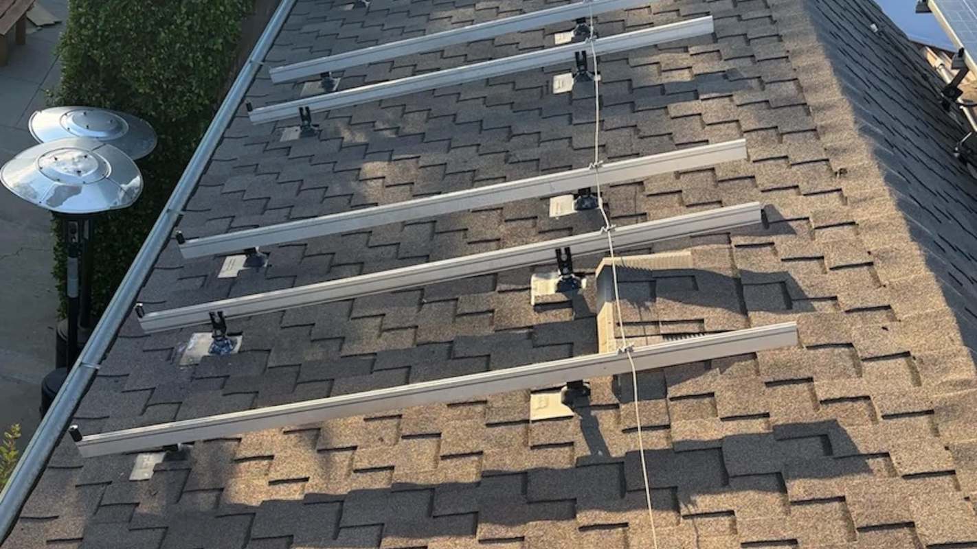 Solar panel mounting brackets installed on a shingled roof.