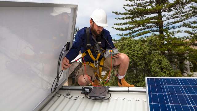 A person installing solar panels.