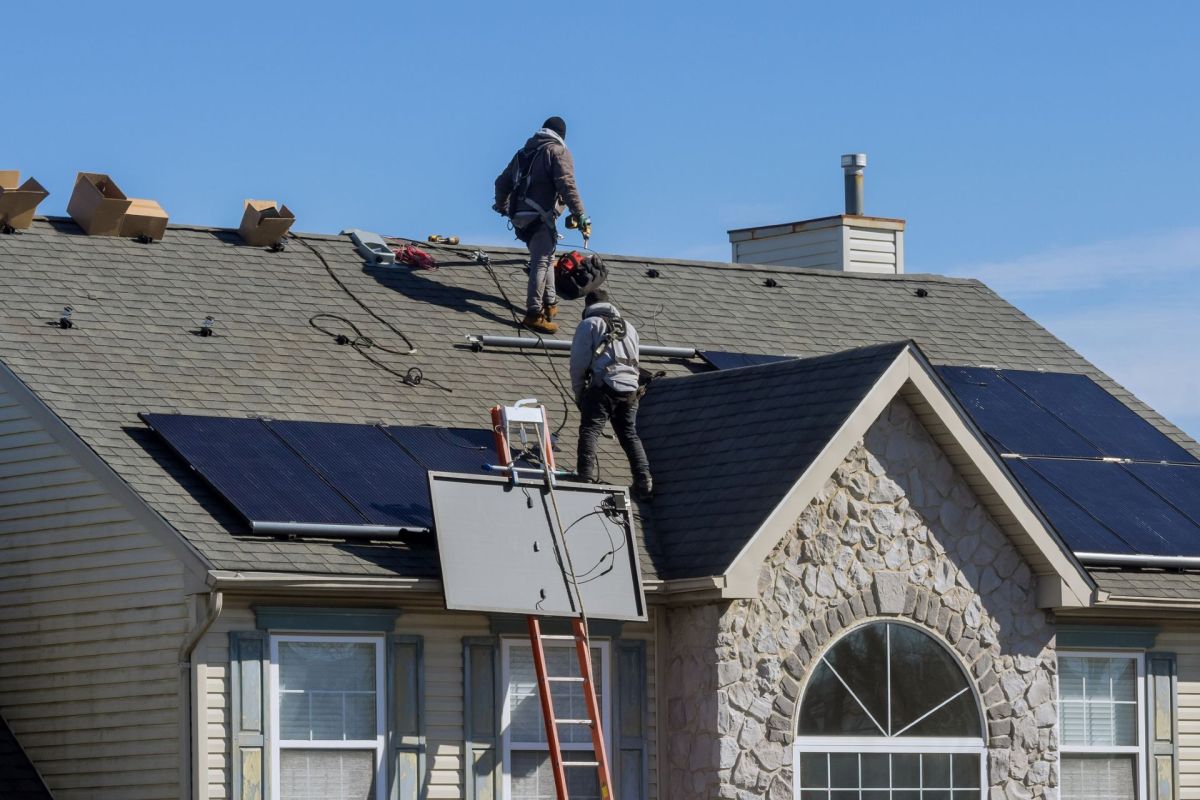 Technicians installing solar panels.