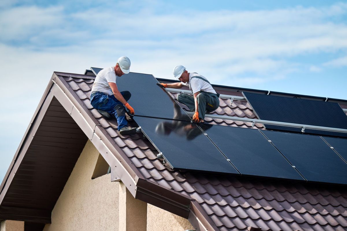 Workers installing solar panels.
