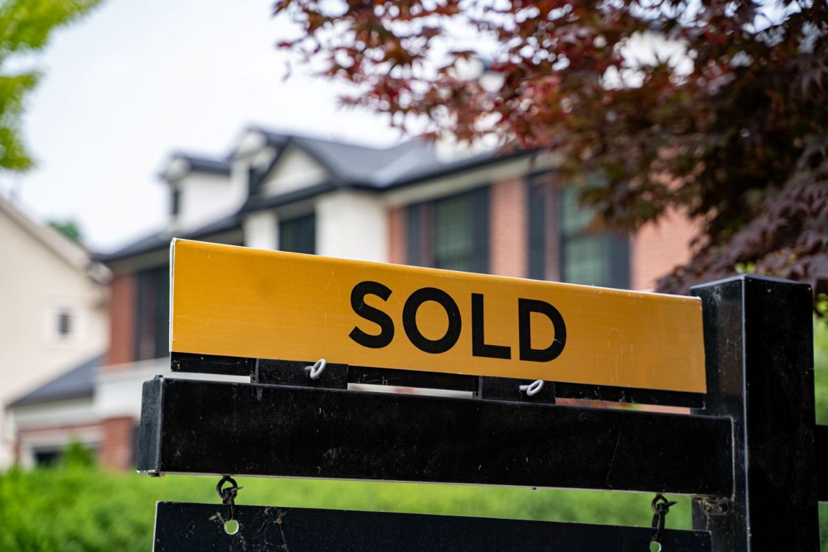 A "sold" sign outside of a home.