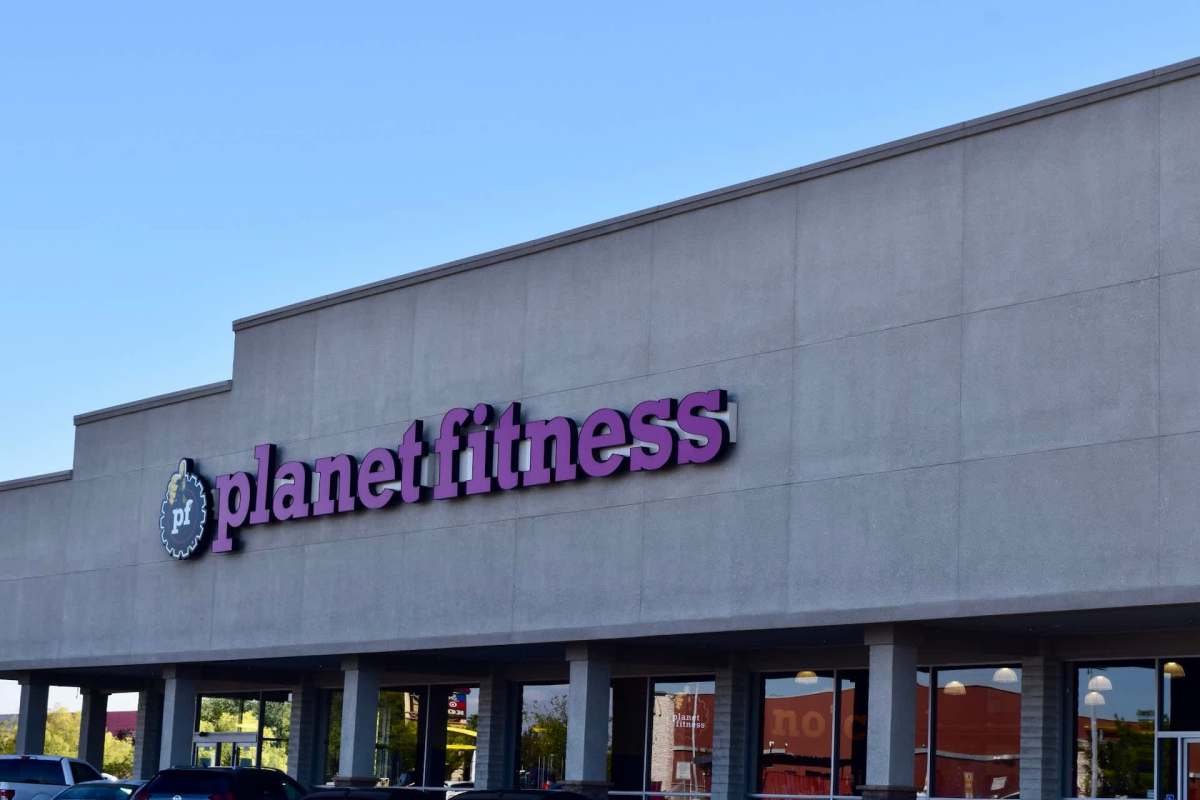 A Planet Fitness gym sign on a building exterior.