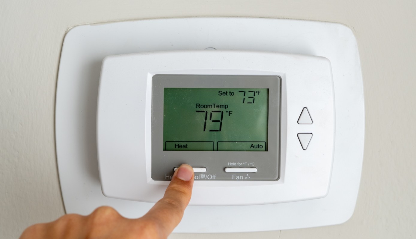 A thermostat displaying a set temperature of 73°F and a room temperature of 79°F.