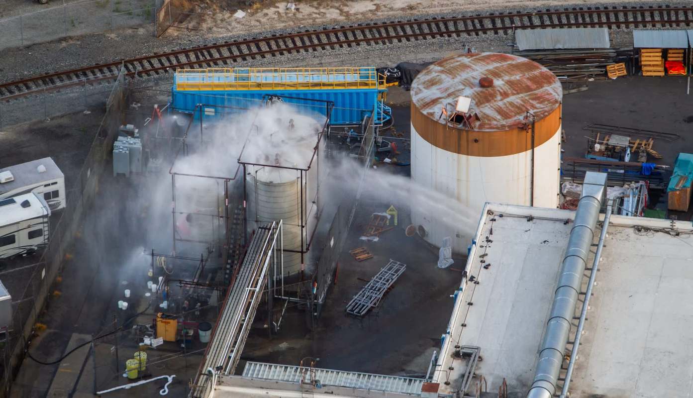 Water spraying at industrial tanks.