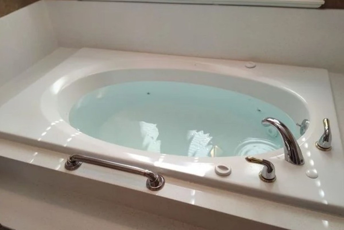 A tub filled with blue water.
