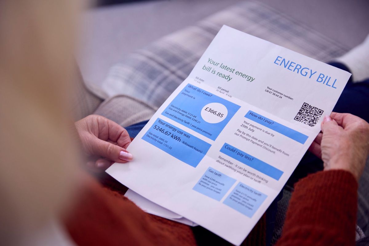 A woman looking at an energy bill.