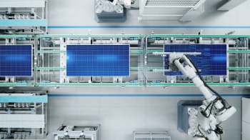 A robotic arm on a solar panel production line.