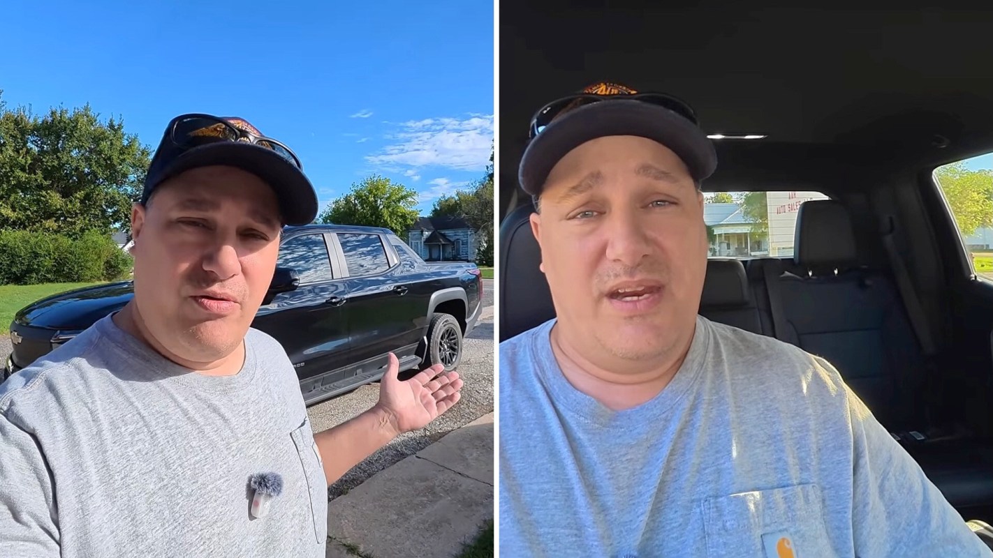 A person stands outside next to a black truck and also appears inside the truck, speaking to the camera.