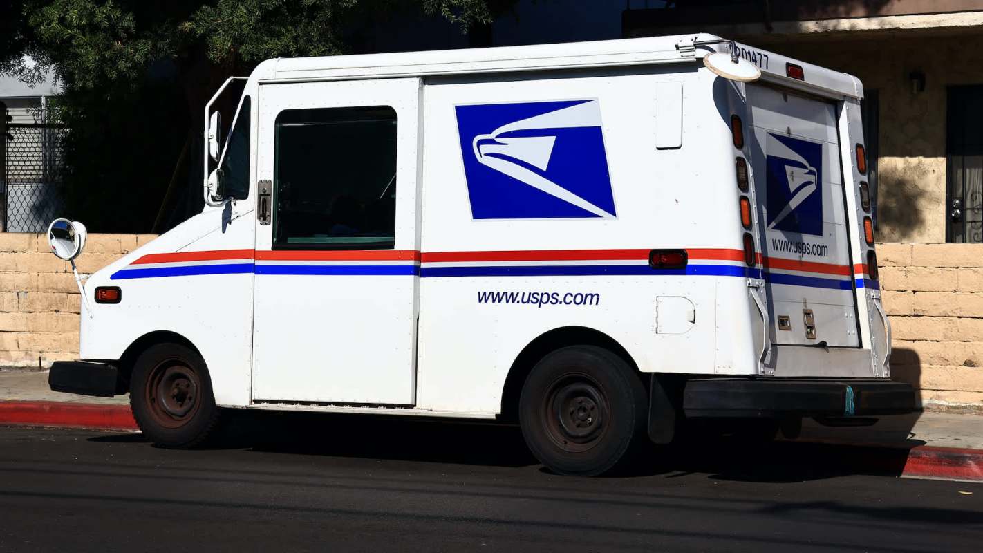 A USPS delivery van parked on the street.