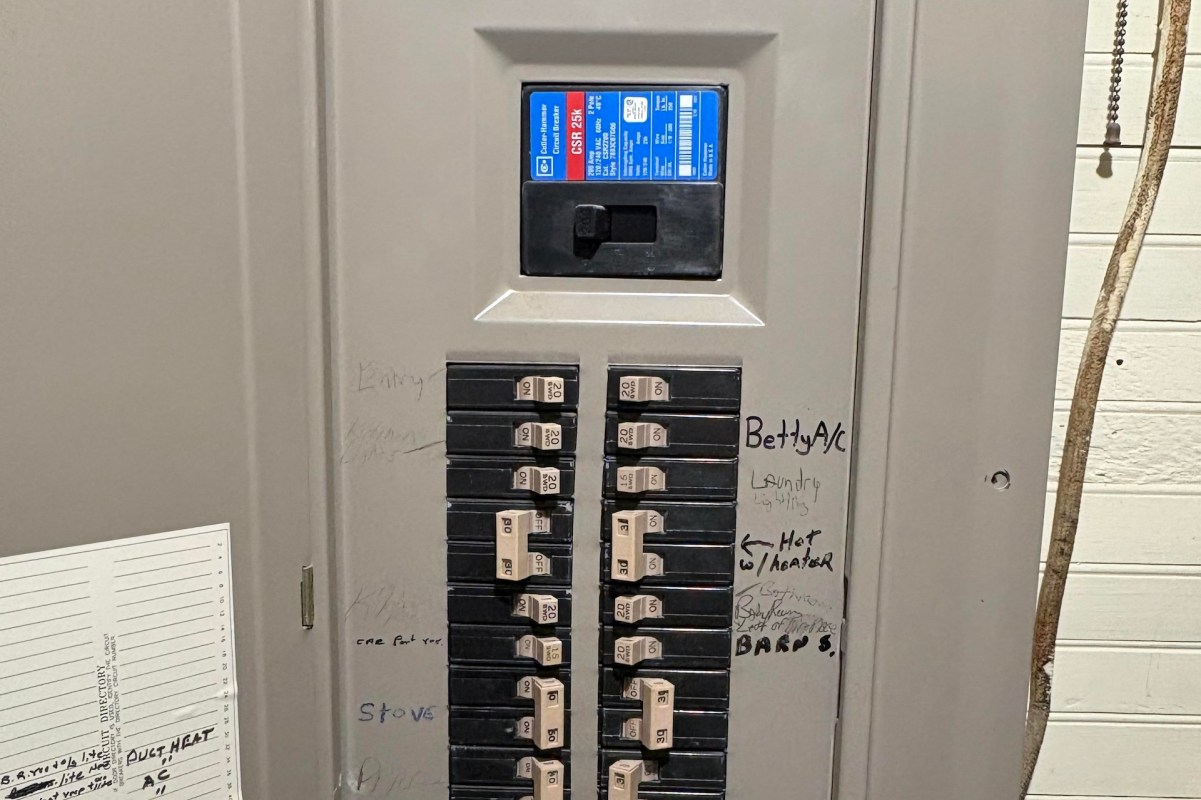 An electrical panel with circuit breakers and labels for various appliances and areas.