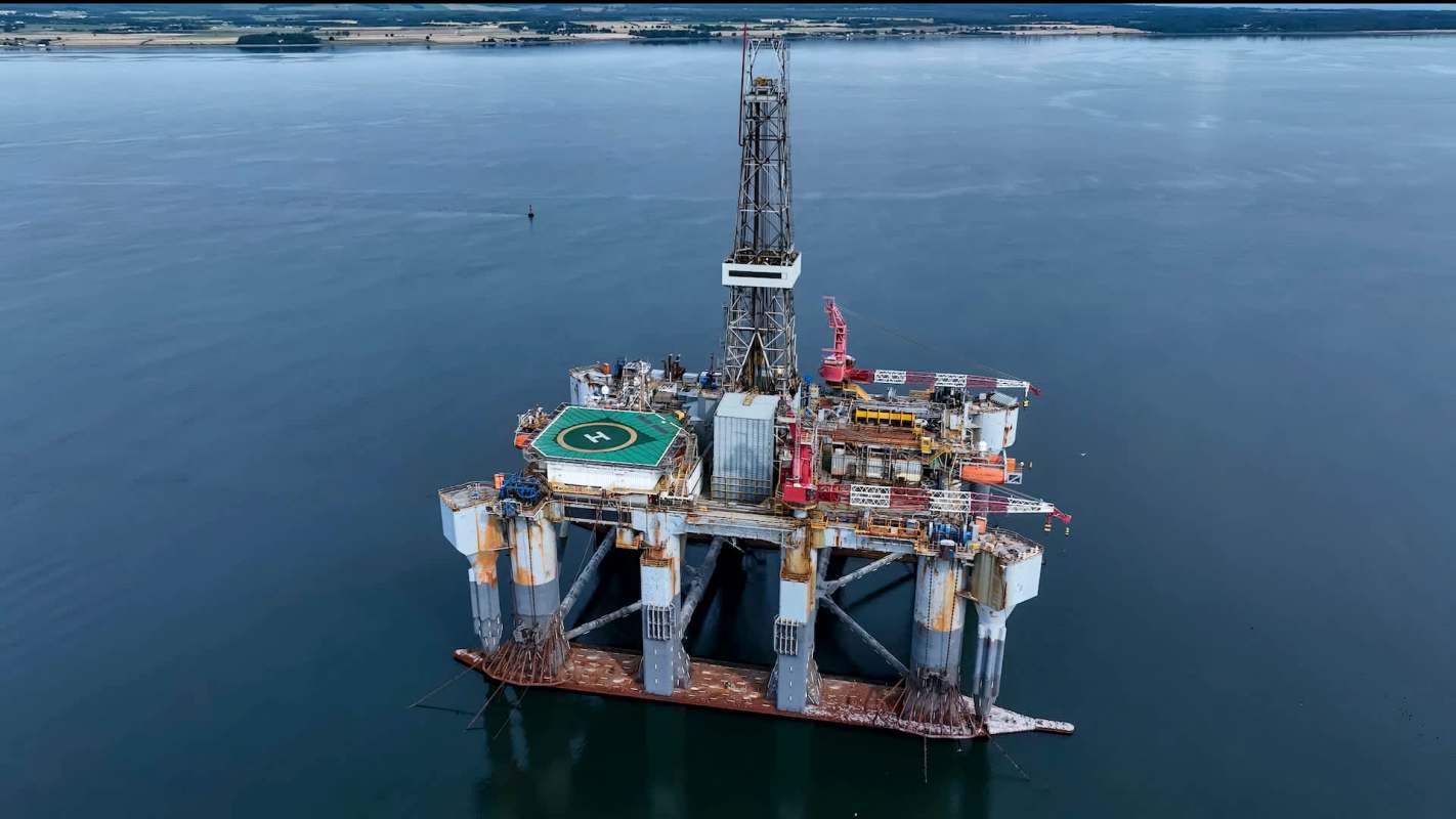 An offshore oil drilling rig in calm water.