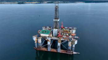 An offshore oil drilling rig in calm water.