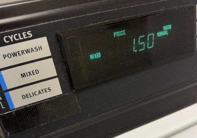 A piece of tape blocking a washing machine's eco cycle.