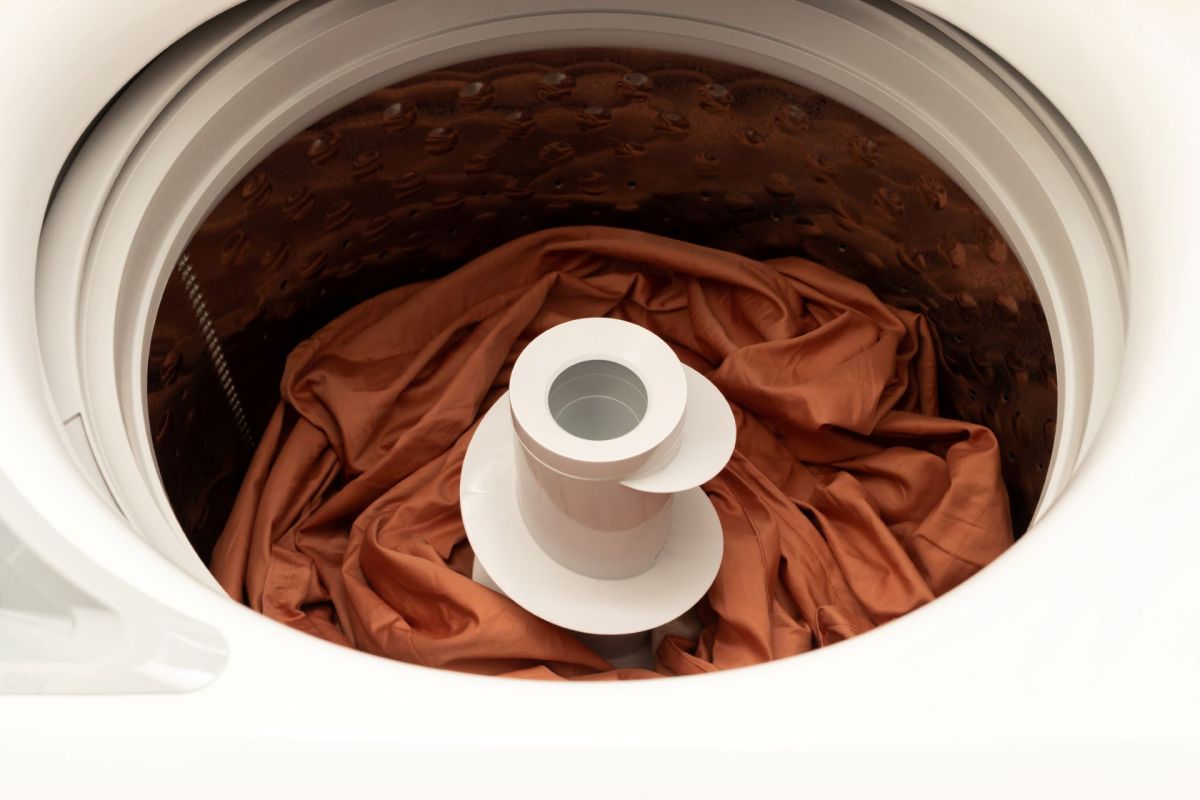 A top-loading washing machine with a drum.