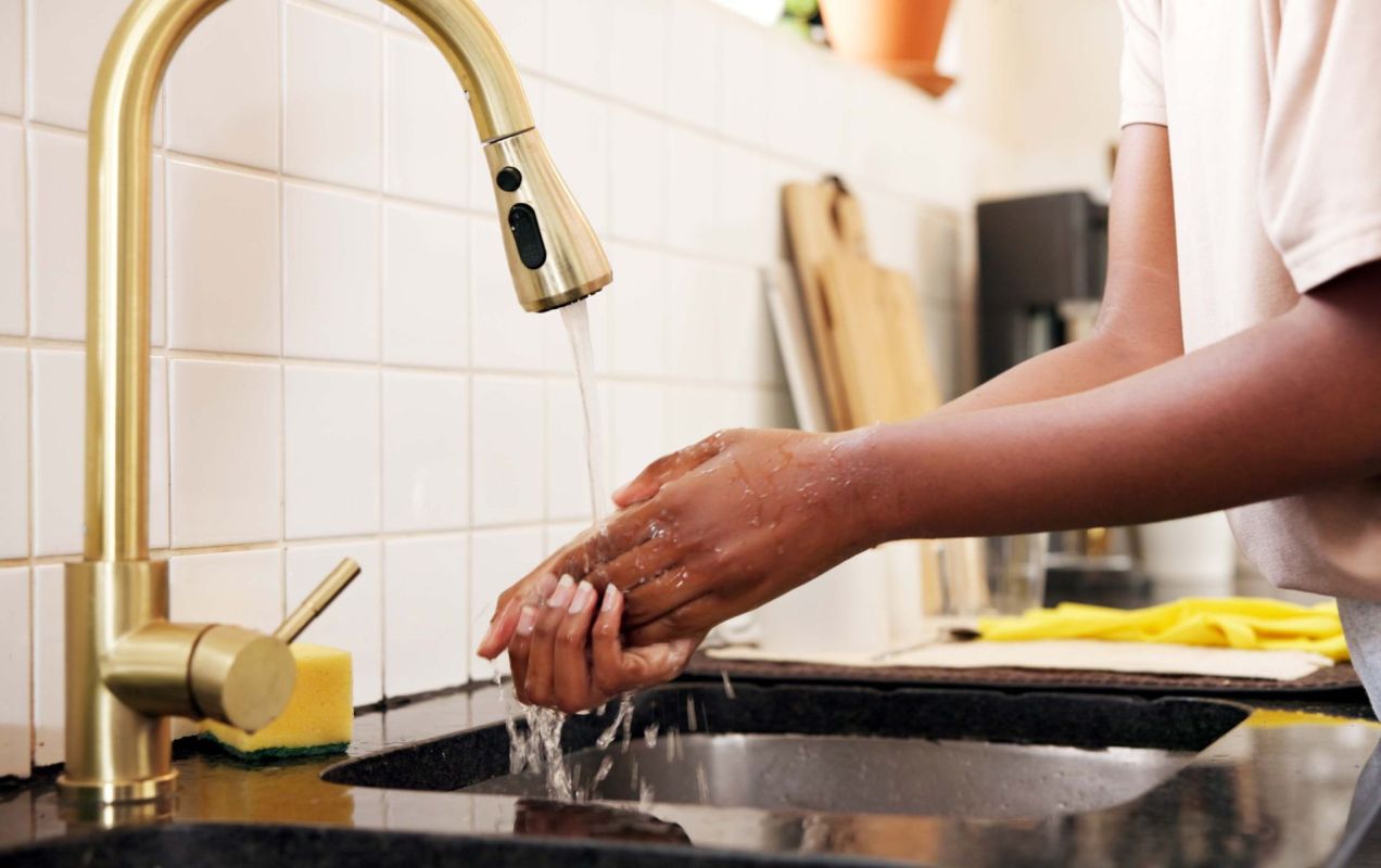 A person washing their hands.