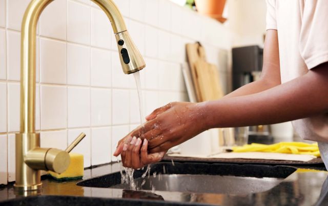 A person washing their hands.