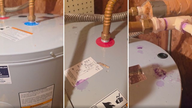 A water heater with various colored pipes and labels, showing signs of water stains and possible leaks.