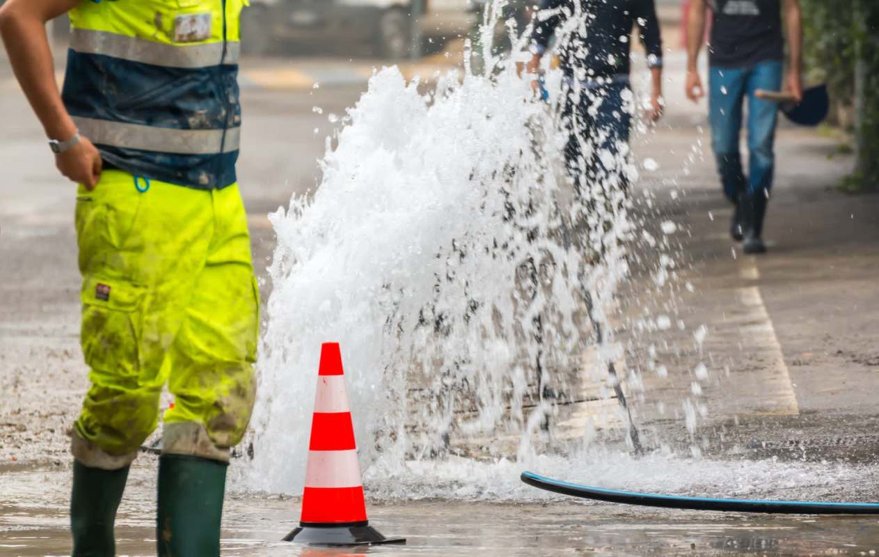 A broken pipe shooting water onto the street.