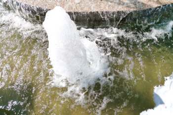 Water shooting up from a water pipe break.