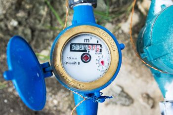 An outside water meter displaying a reading