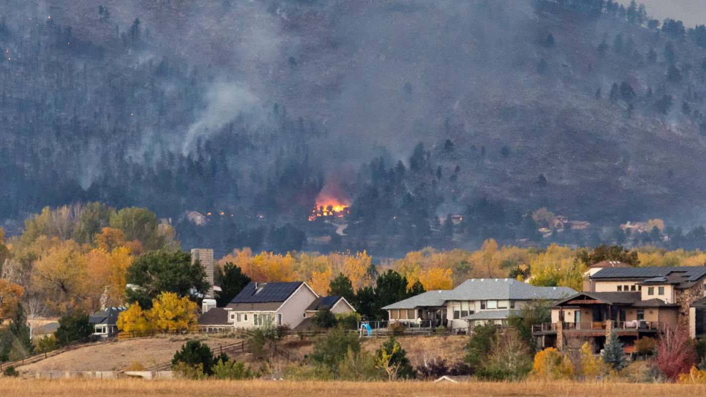 A foothill wildfire over a neighborhood.