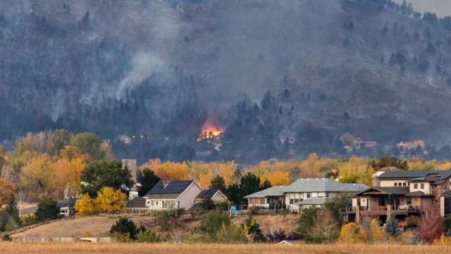 A foothill wildfire over a neighborhood.
